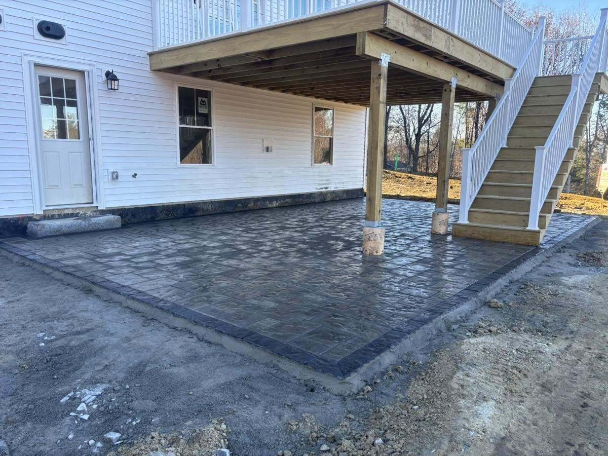 Large paver patio installed beneath a new second-story deck